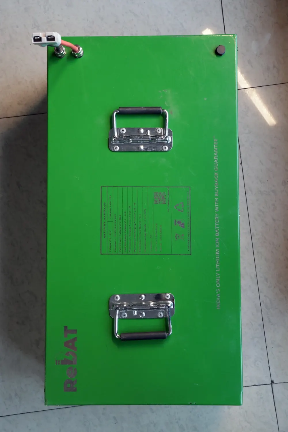 A large green ReBAT battery pack with two carry handles